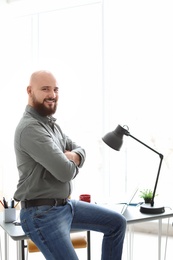 Portrait of confident young man in room