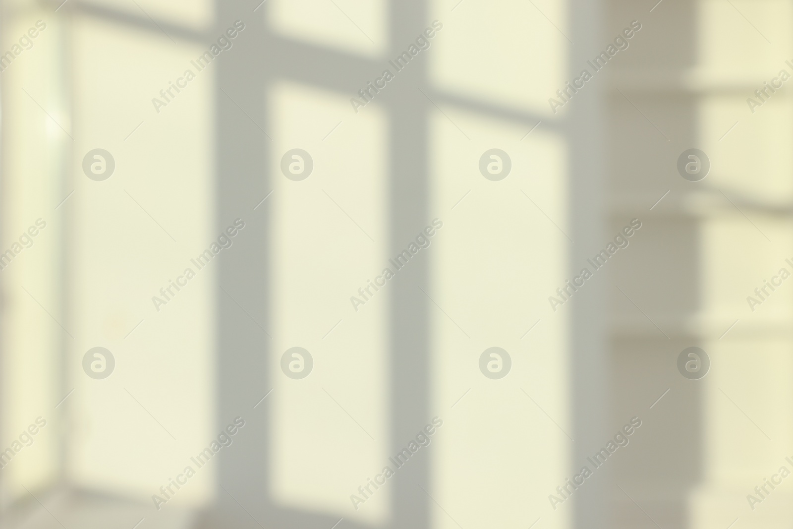 Photo of Blurred view of light and shadows from window on wall indoors