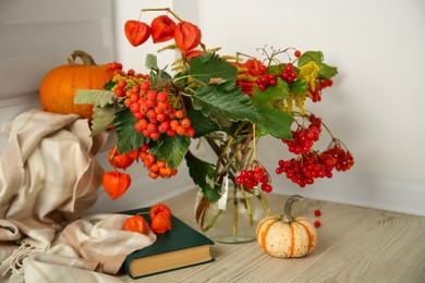 Photo of Beautiful autumn composition with different pumpkins and book indoors