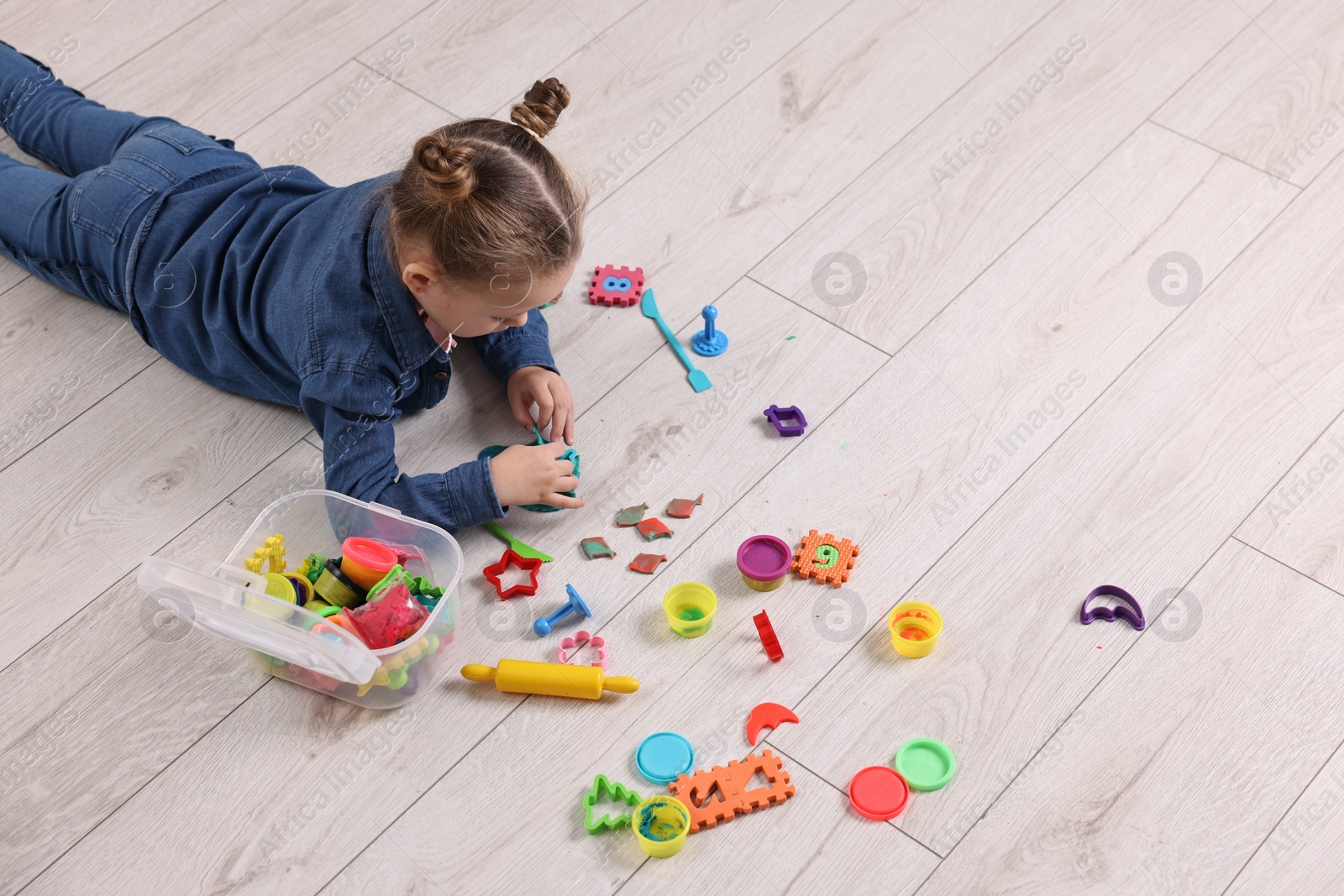 Photo of Cute little girl playing on warm floor at home, space for text. Heating system