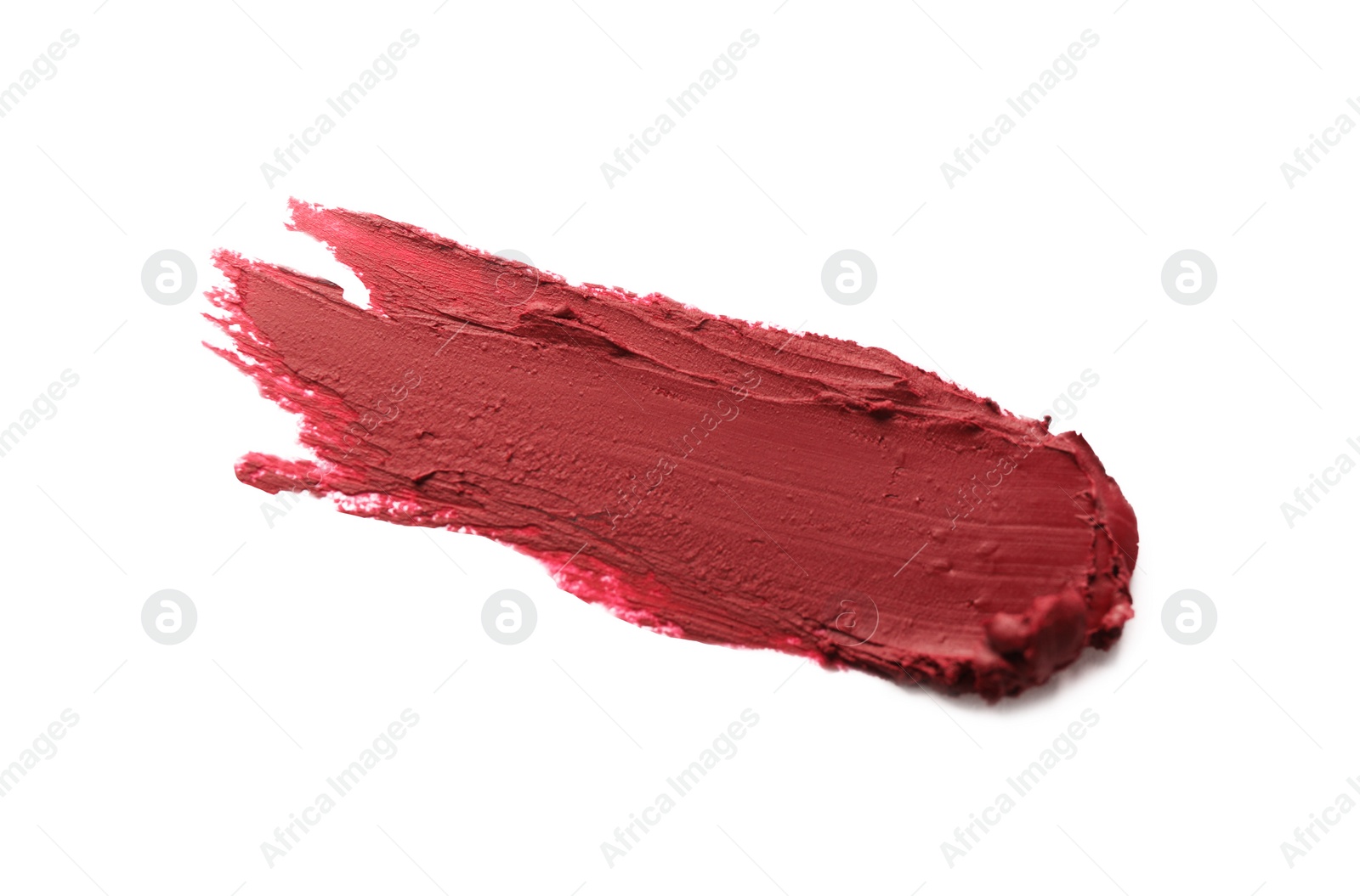 Photo of Smear of bright lipstick on white background, top view