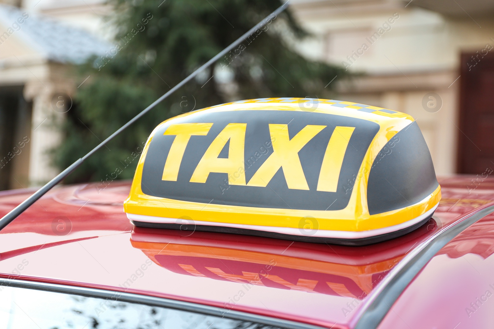 Photo of Roof light with word TAXI on car outdoors