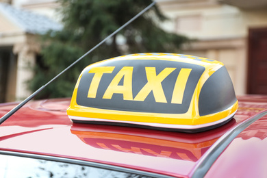 Photo of Roof light with word TAXI on car outdoors