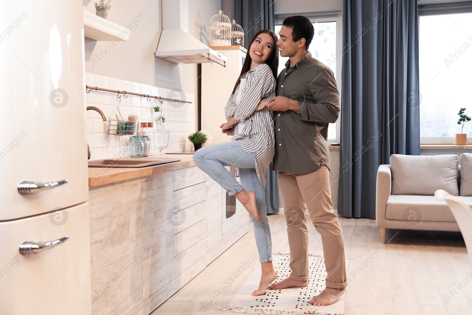 Photo of Lovely young interracial couple dancing at home