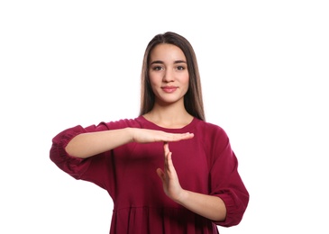 Photo of Woman showing TIME OUT gesture in sign language on white background