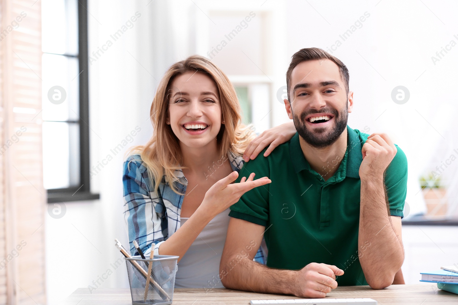 Photo of Happy couple using video chat for conversation indoors