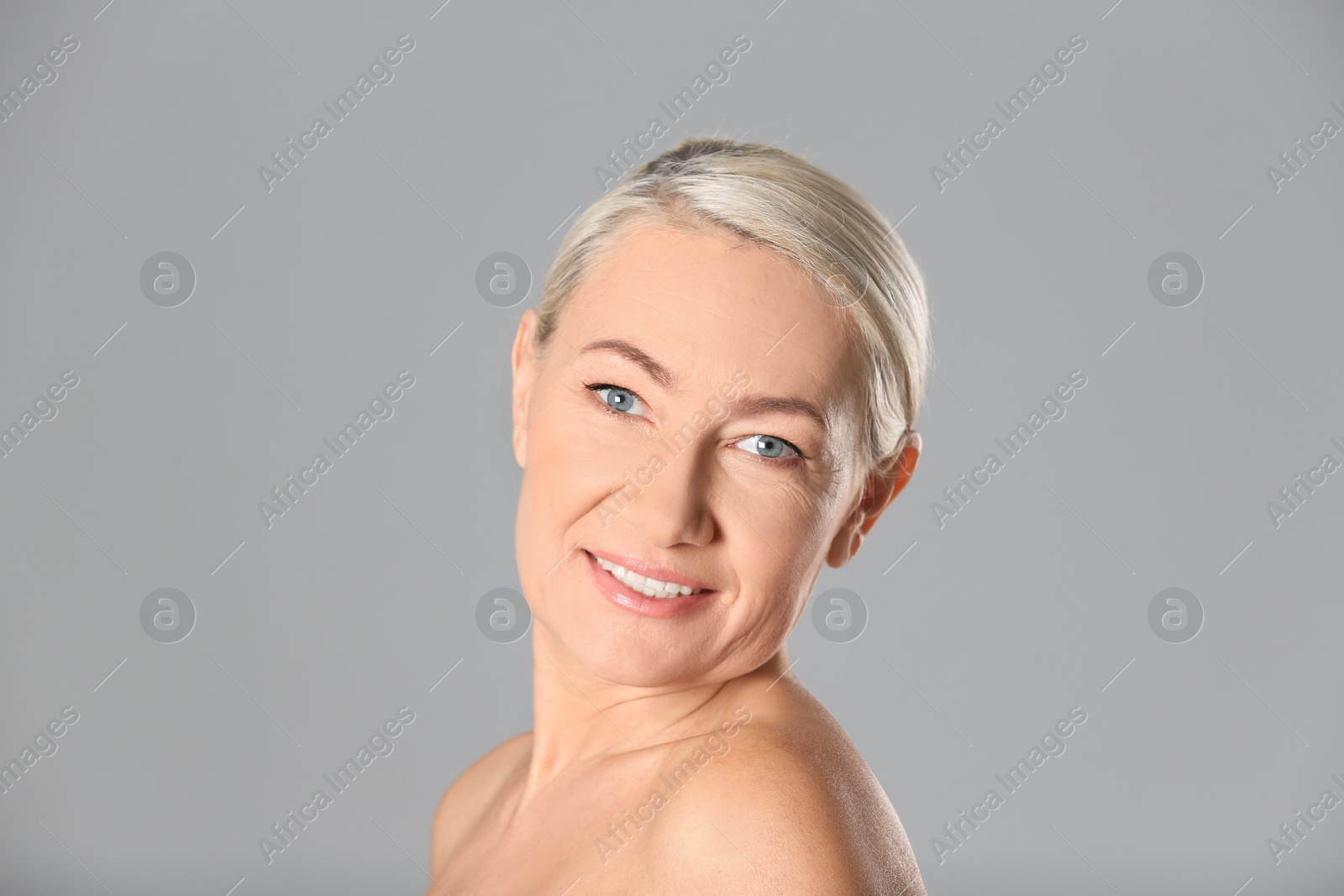 Photo of Portrait of beautiful mature woman on grey background