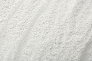 Photo of Texture of baking powder as background, top view