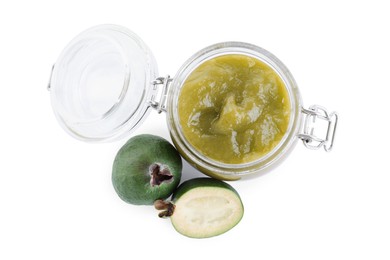 Photo of Feijoa jam in glass jar and fruits on white background, top view