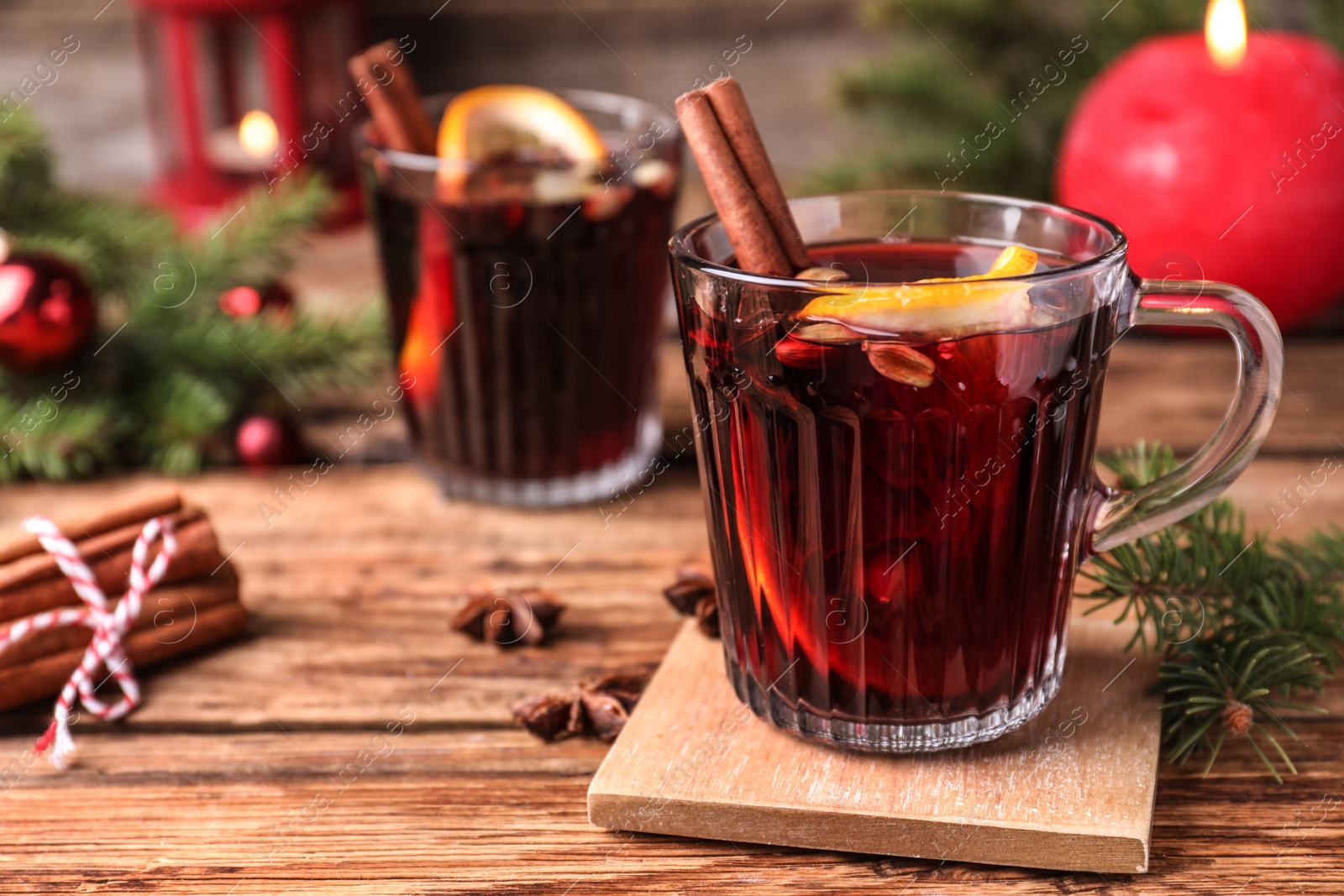 Photo of Aromatic mulled wine on wooden table, space for text