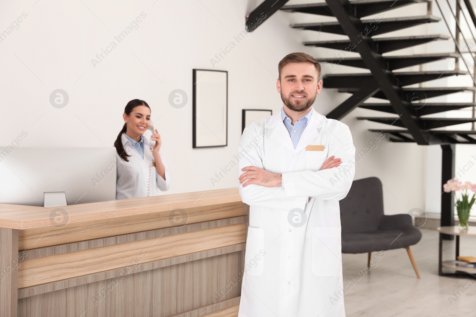Photo of Professional staff working at reception in modern clinic