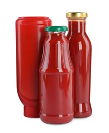 Different bottles of ketchup on white background