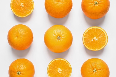 Composition with ripe oranges on white background, top view