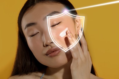 Image of Beautiful woman applying sunscreen onto face against golden background. Illustration of shield symbolizing sun protection