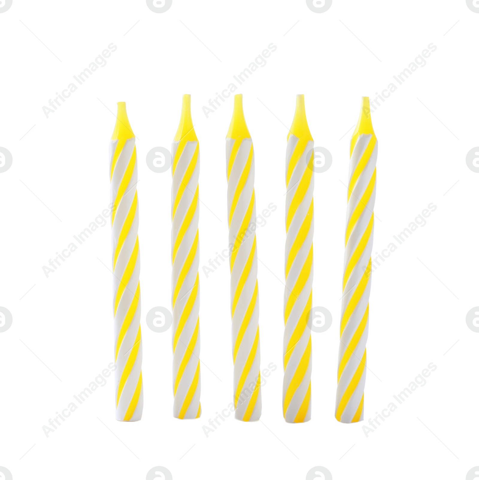 Photo of Yellow striped birthday candles isolated on white