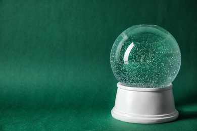 Photo of Magical empty snow globe on color background. Space for text