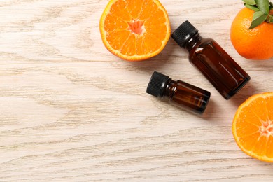 Photo of Flat lay composition with tangerine essential oil on wooden table. Space for text