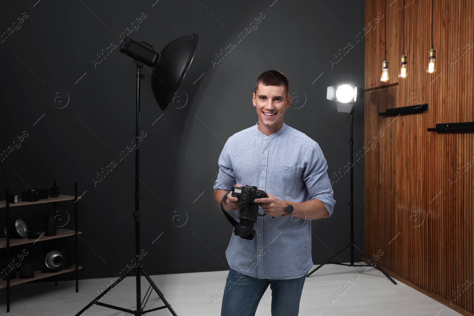 Photo of Professional photographer with modern camera in studio