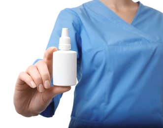 Female doctor holding plastic bottle with medicament on white background, closeup. Medical object