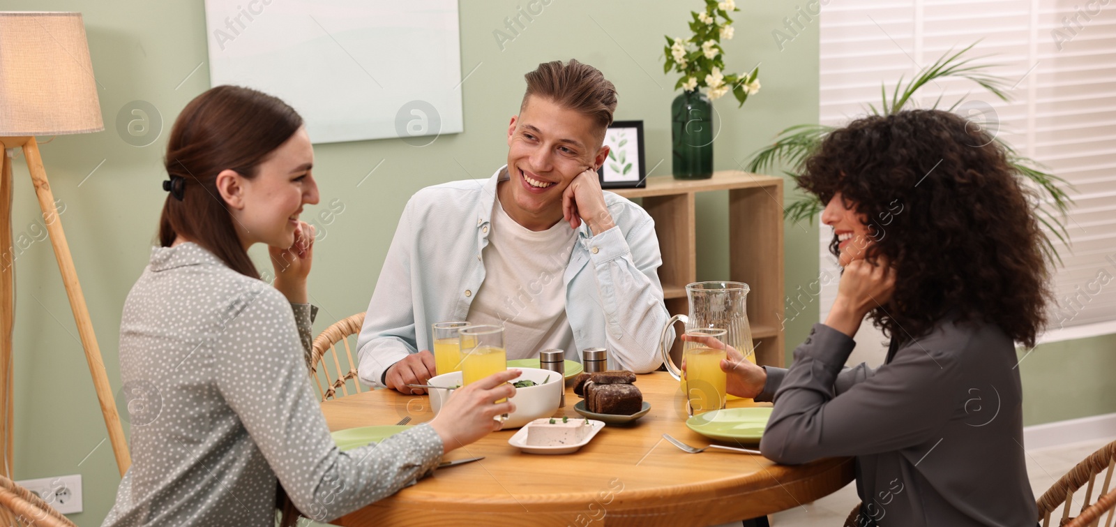 Photo of Happy friends having vegetarian meal in cafe