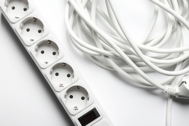 Extension cord on white background, top view. Electrician's equipment