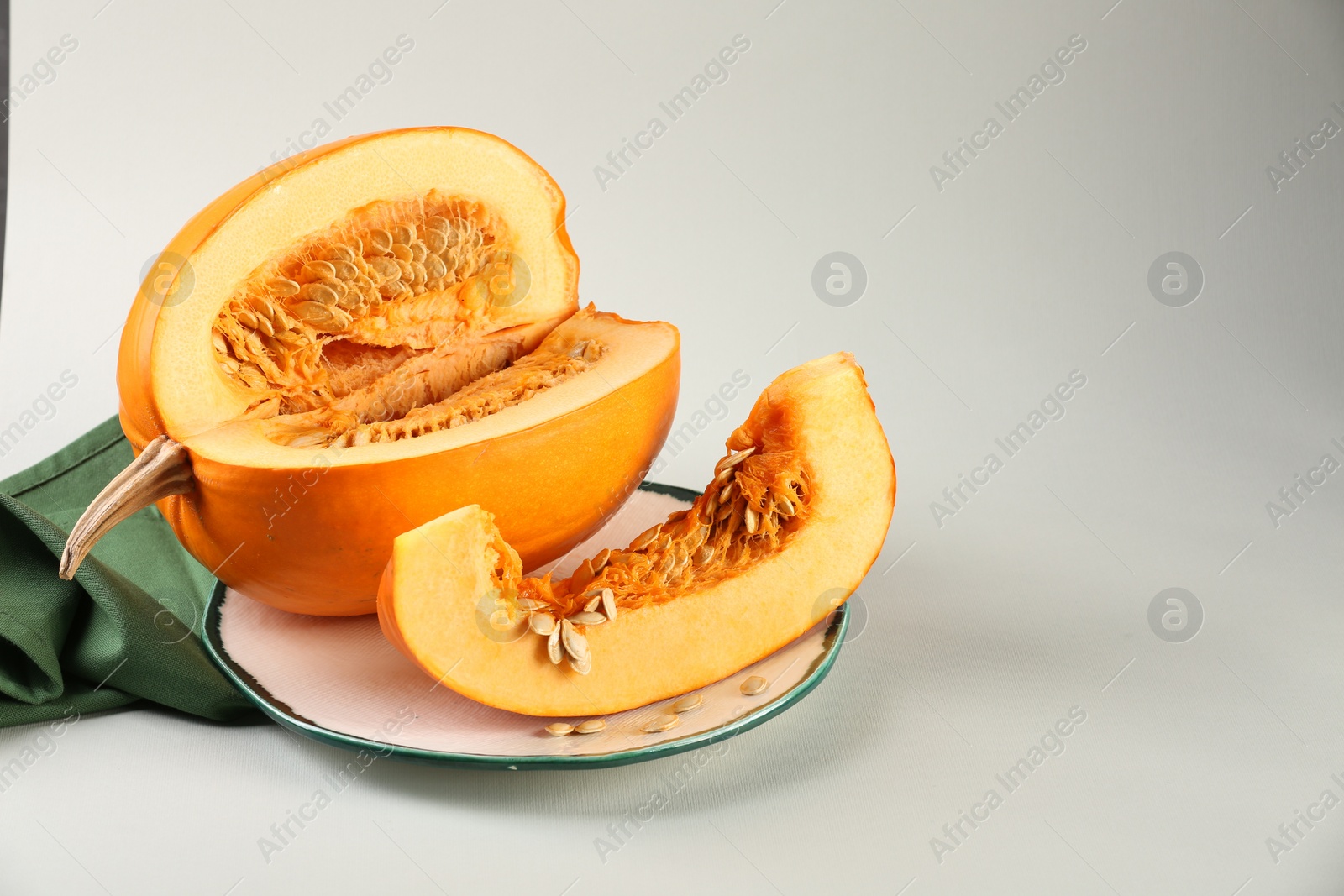 Photo of Cut fresh ripe pumpkin on white background, space for text