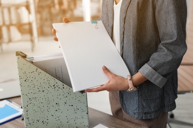 Photo of Businesswoman working with documents at office table, closeup