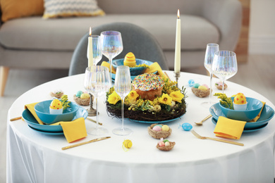 Photo of Festive Easter table setting with beautiful floral decor and eggs indoors