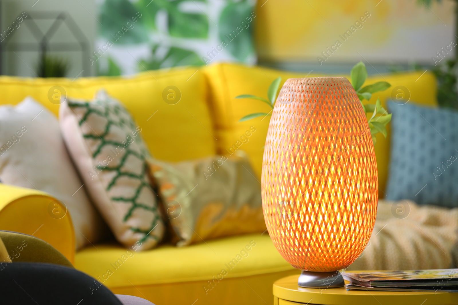 Photo of Stylish lamp on table in living room. Interior design element