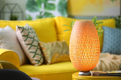 Stylish lamp on table in living room. Interior design element