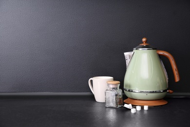 Composition with tea set on table in kitchen. Space for text