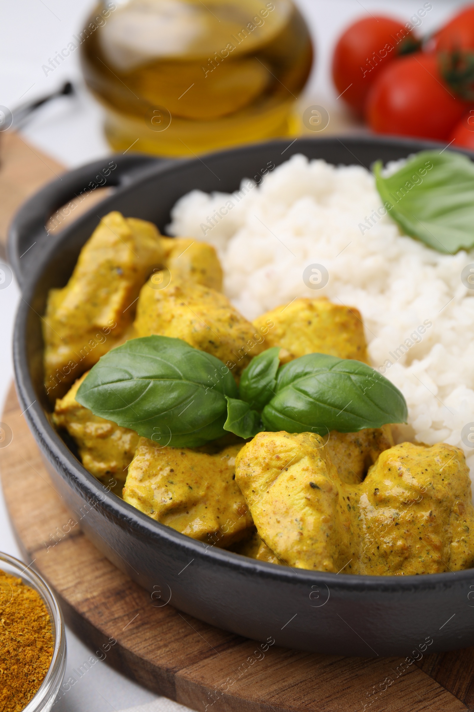 Photo of Delicious rice and chicken with curry sauce on table, closeup