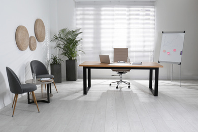 Photo of Director's office with large wooden table. Interior design