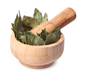 Photo of Wooden mortar with aromatic bay leaves and pestle isolated on white