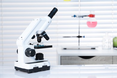 Photo of Laboratory analysis. Modern medical microscope on white table indoors, space for text