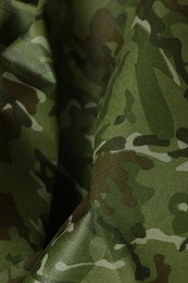 Photo of Texture of crumpled camouflage fabric as background, closeup