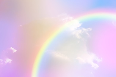 Image of Amazing sky with rainbow and fluffy clouds, toned in unicorn colors