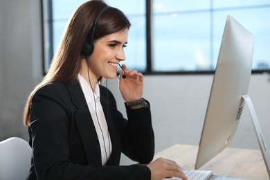 Photo of Technical support operator with headset in modern office