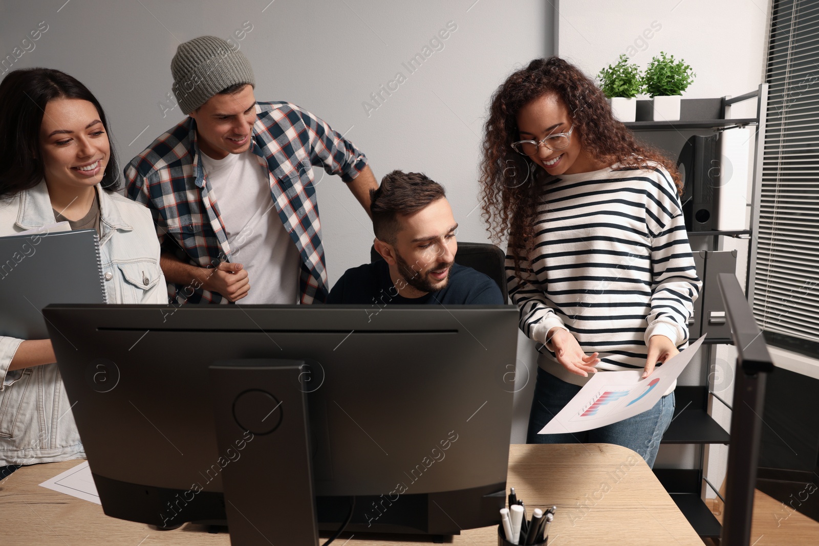 Photo of Team of employees working together in office. Startup project