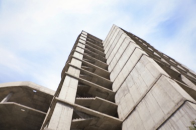 Blurred view of unfinished building outdoors. Construction safety rules