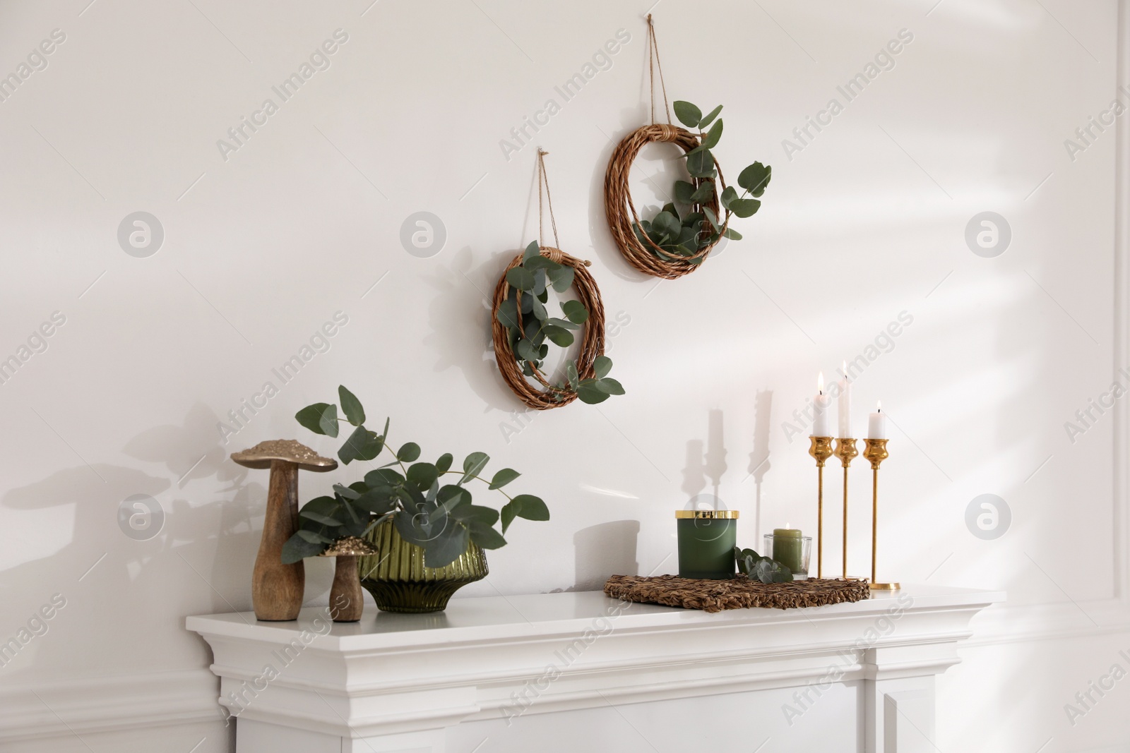 Photo of Stylish room with beautiful fireplace and eucalyptus branches