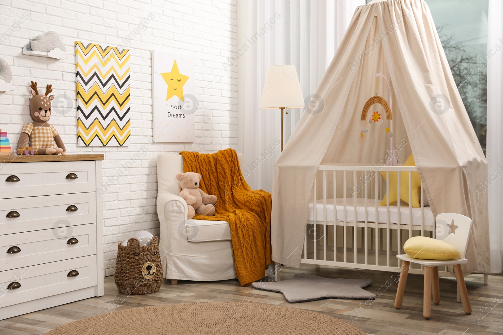 Photo of Stylish baby's room with comfortable cot. Interior design