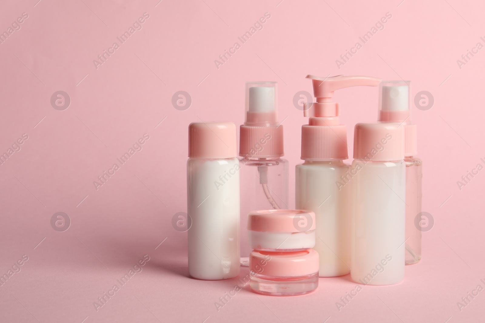 Photo of Cosmetic travel on pink background. Space for text