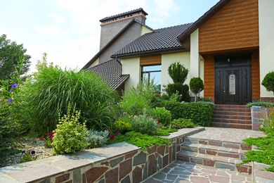 Photo of Beautiful green garden near modern house on sunny day