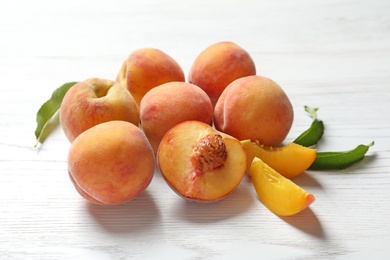 Fresh sweet peaches on wooden table