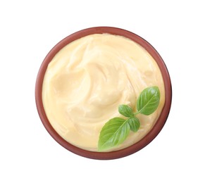 Photo of Tasty cheese sauce with basil in bowl isolated on white, top view