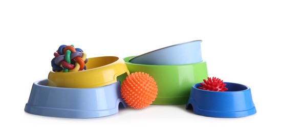 Photo of Feeding bowls and dog toys on white background