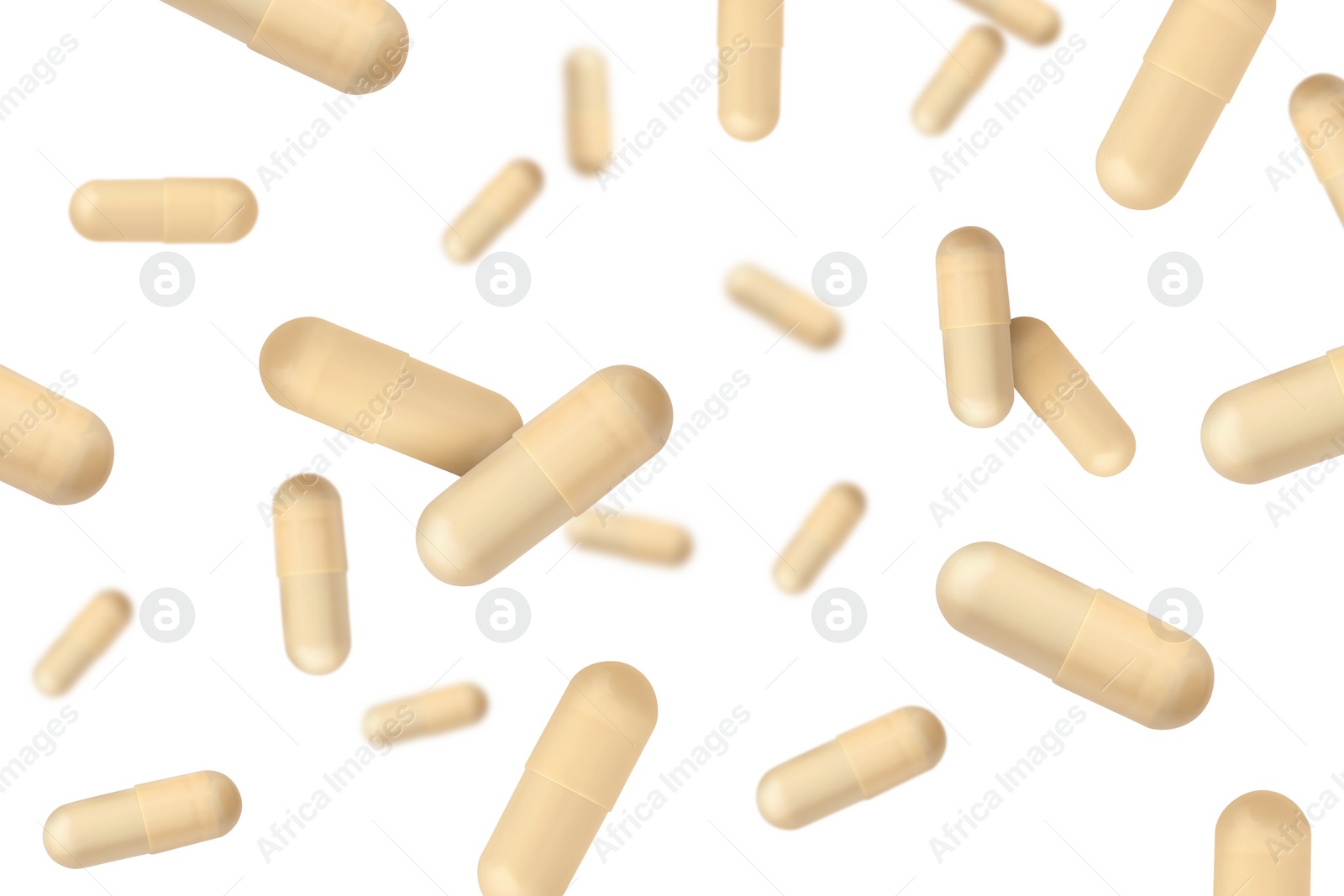 Image of Vitamin. Many capsules falling on white background