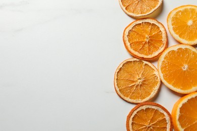 Photo of Dry orange slices on white table, flat lay. Space for text