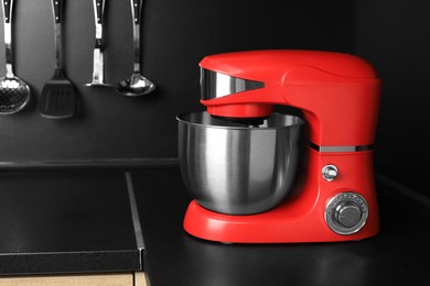 Photo of Modern stand mixer on countertop in kitchen. Space for text